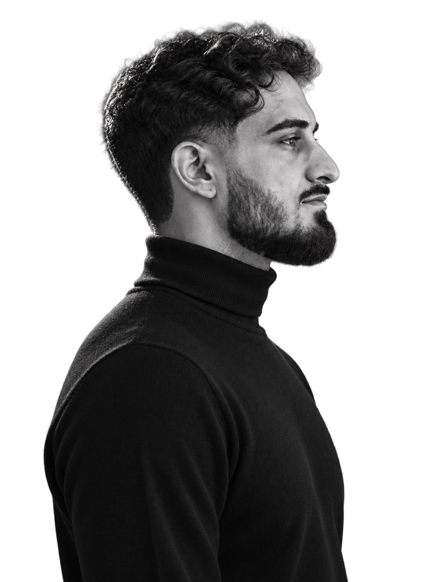 Bilal Hashimi in profile, wearing a black turtleneck